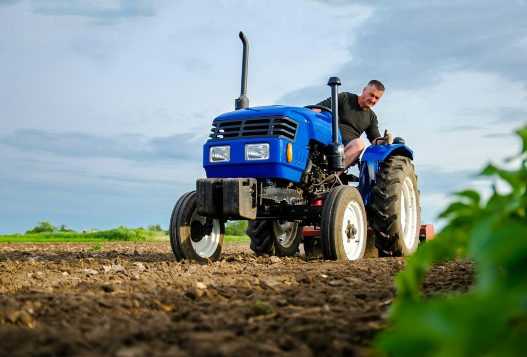 A farmer on a tractor works in the field.